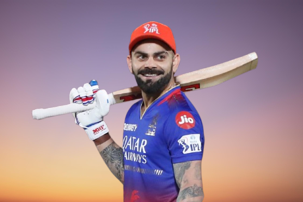 Richest Cricketers: Virat Kohli smiling and holding his bat on his right shoulder, wearing IPL blue uniform.