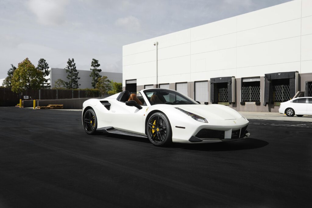 Sports Car perfection - A sleek white Ferrari 488 Spider parked on the road, showcasing its stunning design