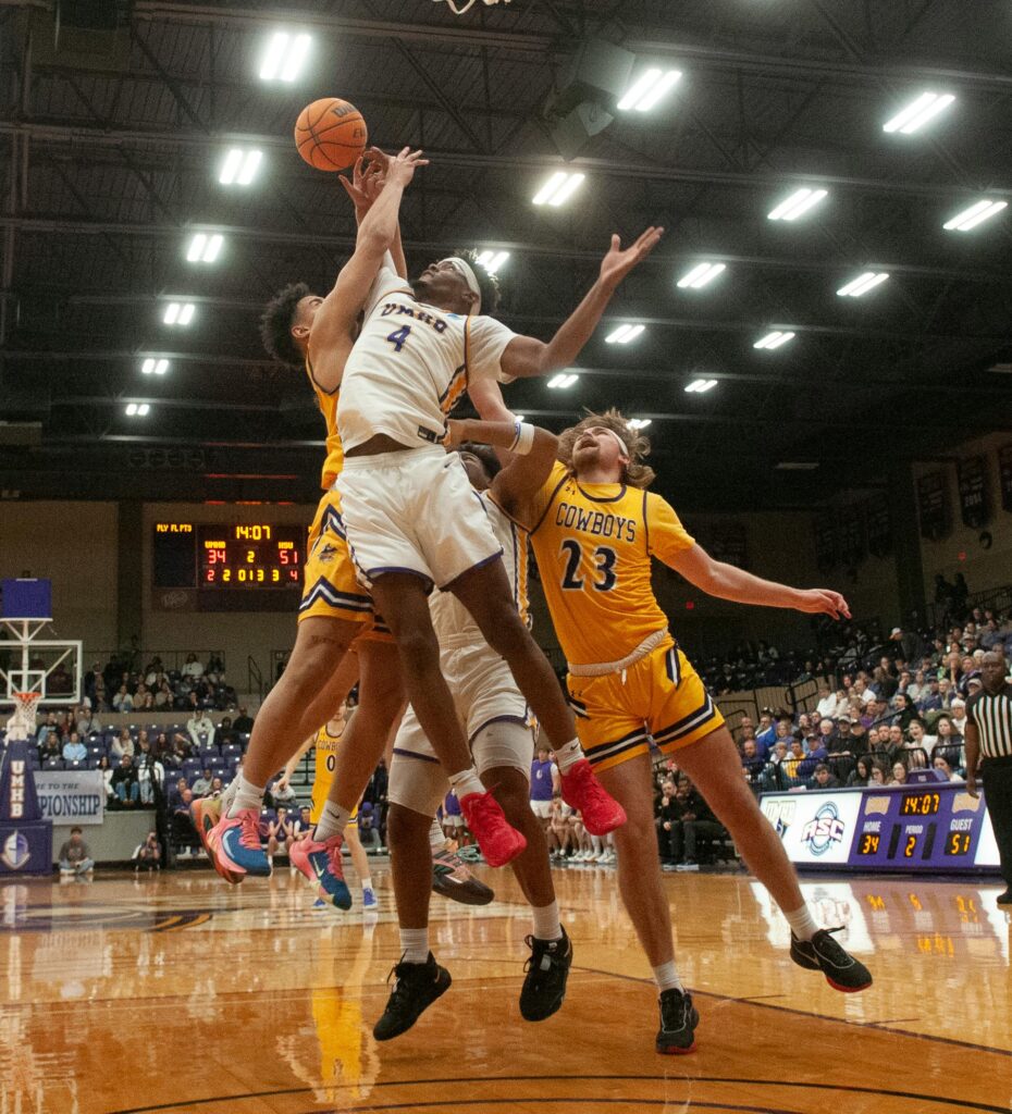 Basketball enthusiasts engage in intense gameplay, showcasing teamwork and athleticism