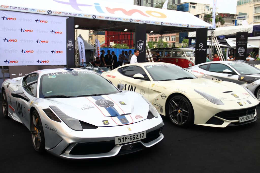 Sports Car enthusiasts explore luxurious, best and successful Sports cars at outdoor auto event, various high-end cars on display