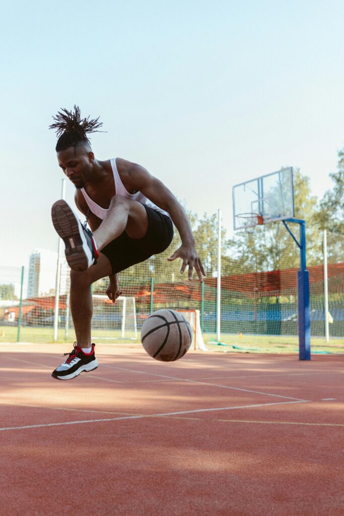 Basketball Player Soars Through Air with Ball
