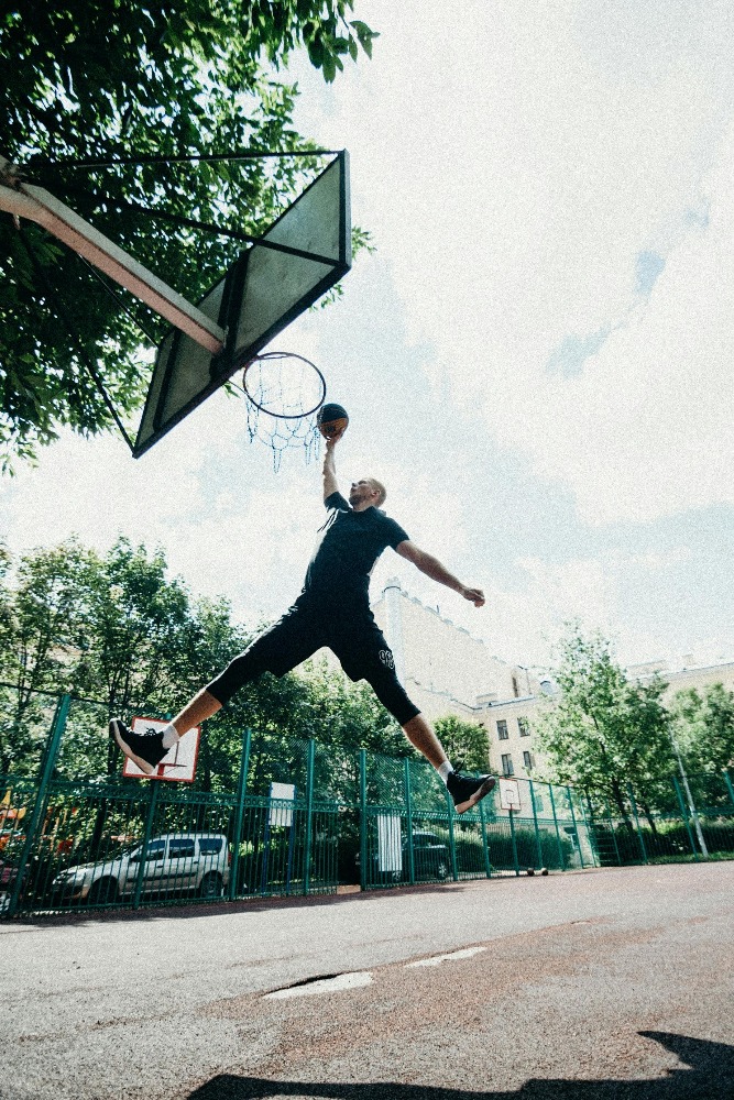 Basketball player leaps into the air, showcasing flawless jump shot form